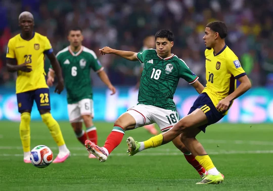 Mexico player challenges Ecuador player for ball Mexico player challenges Ecuador player for ball