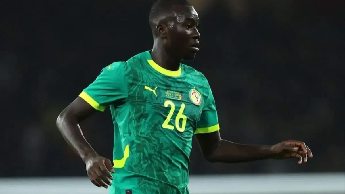 Senegal player wearing green jersey during match Senegal player wearing green jersey during match