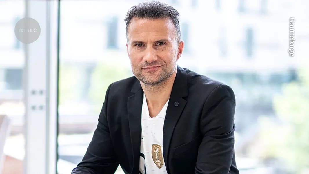 Man in black blazer sitting indoors, looking at camera Man in black blazer sitting indoors, looking at camera