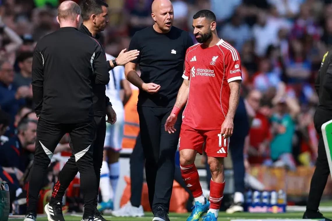 Mohamed Salah walking off with coaching staff Mohamed Salah walking off with coaching staff