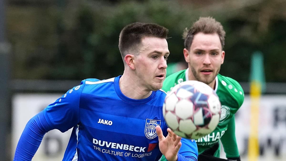Player chasing the ball during football match Player chasing the ball during football match
