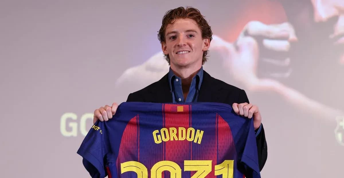 Player holding FC Barcelona jersey at presentation Player holding FC Barcelona jersey at presentation