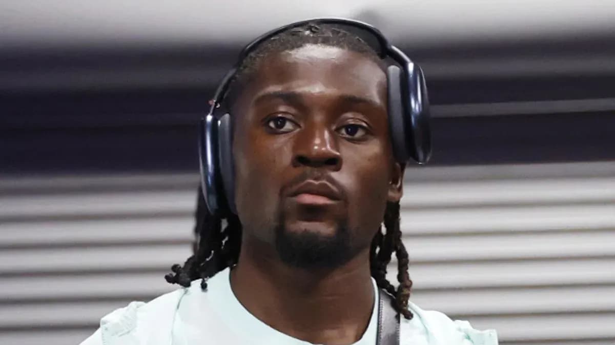 Athlete wearing headphones, walking in a corridor Athlete wearing headphones, walking in a corridor