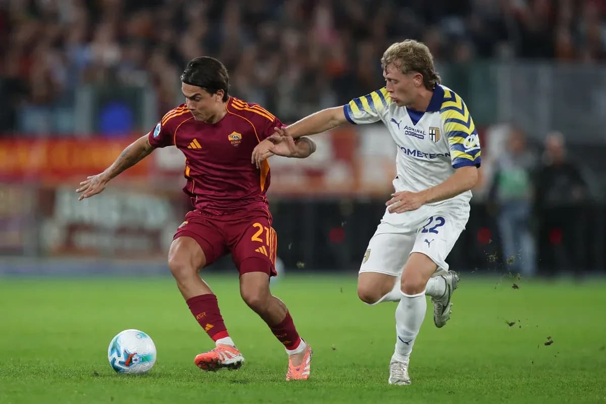AS Roma player evading Parma defender during match AS Roma player evading Parma defender during match