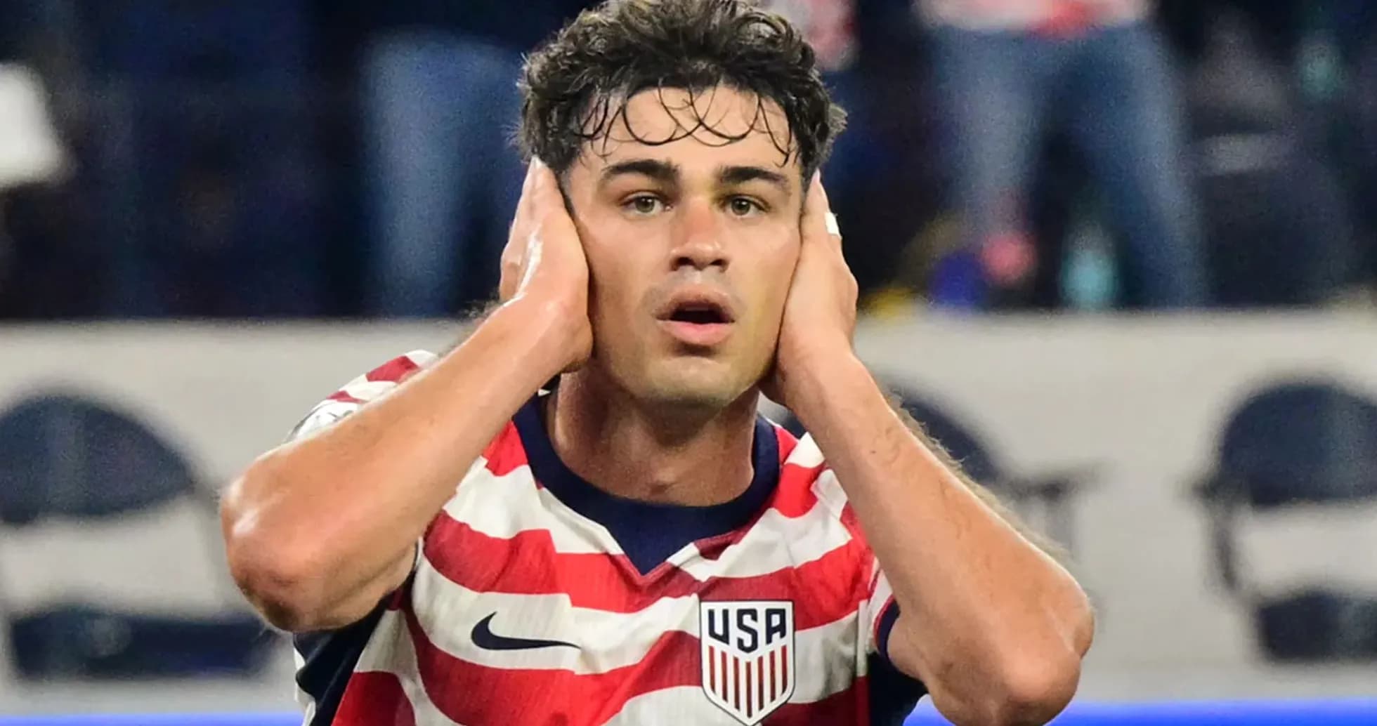 Player in USA jersey reacting during a match Player in USA jersey reacting during a match
