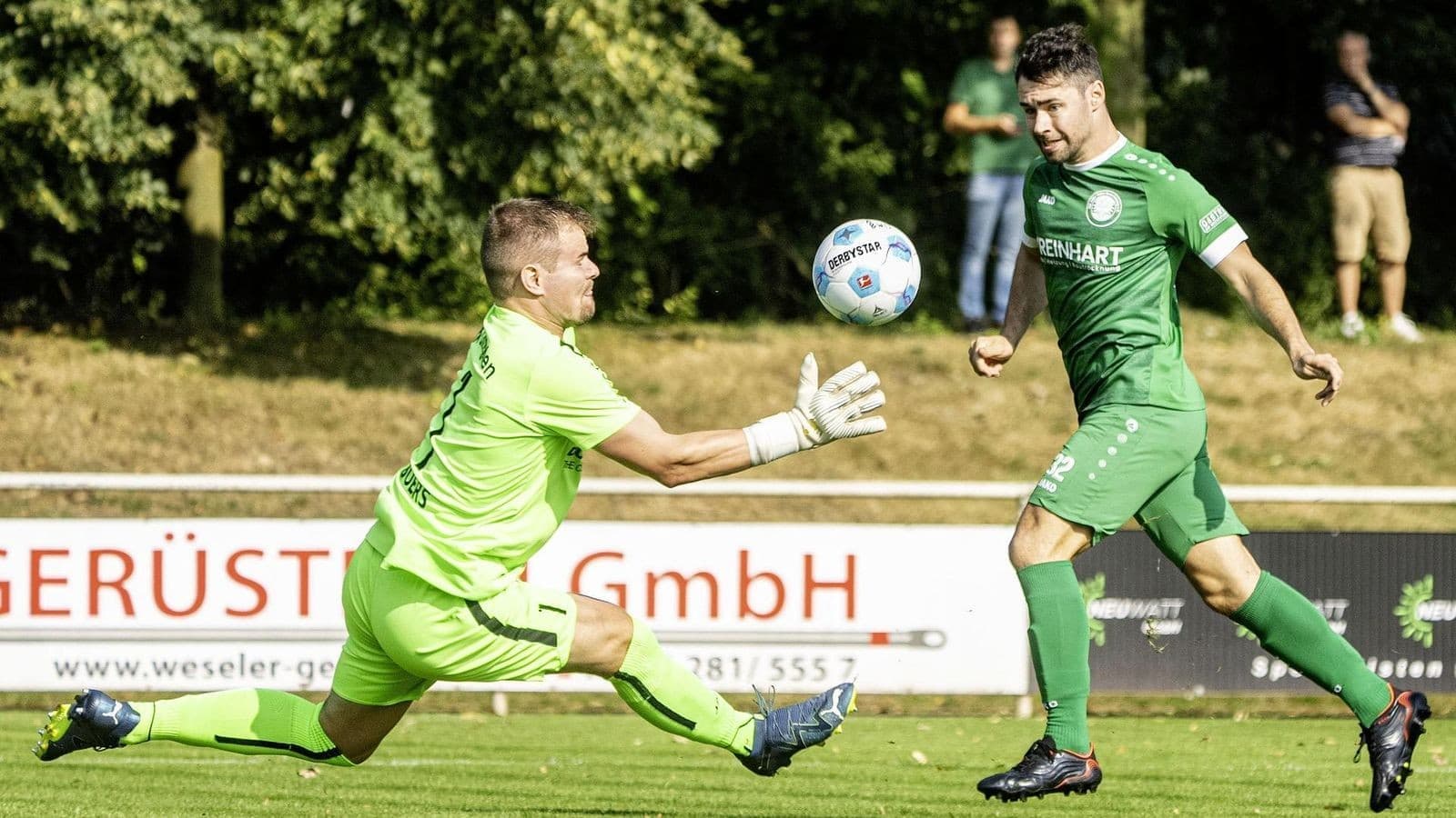 Goalkeeper attempting to catch the ball during match Goalkeeper attempting to catch the ball during match