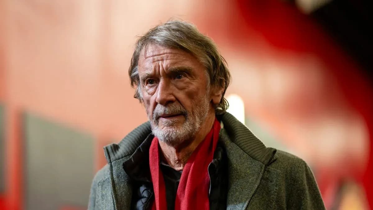Man wearing a gray coat and red scarf Man wearing a gray coat and red scarf