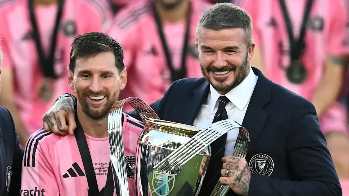 Lionel Messi and David Beckham holding trophy Lionel Messi and David Beckham holding trophy