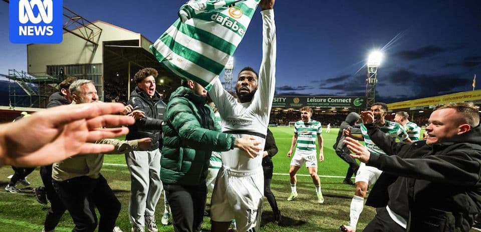 Player celebrating with fans after a match Player celebrating with fans after a match
