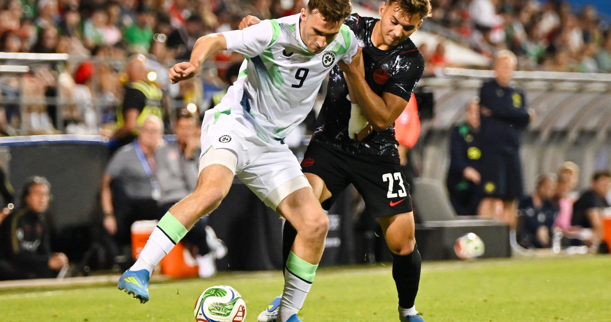 Two players contesting for the ball during match Two players contesting for the ball during match
