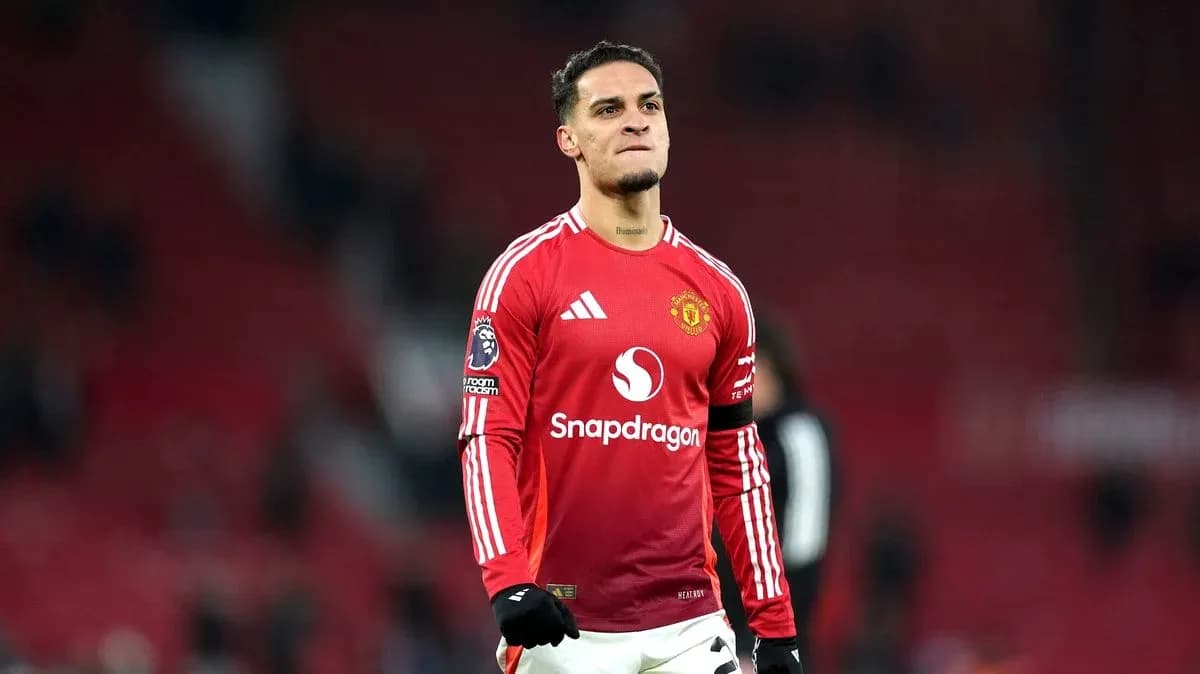 Player in Manchester United kit celebrating on field Player in Manchester United kit celebrating on field