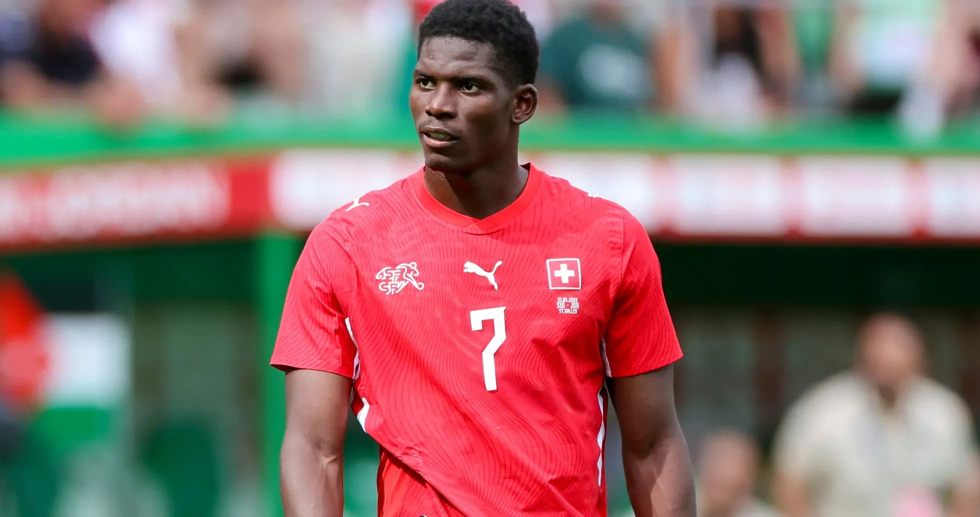 Player wearing red Swiss jersey on field Player wearing red Swiss jersey on field