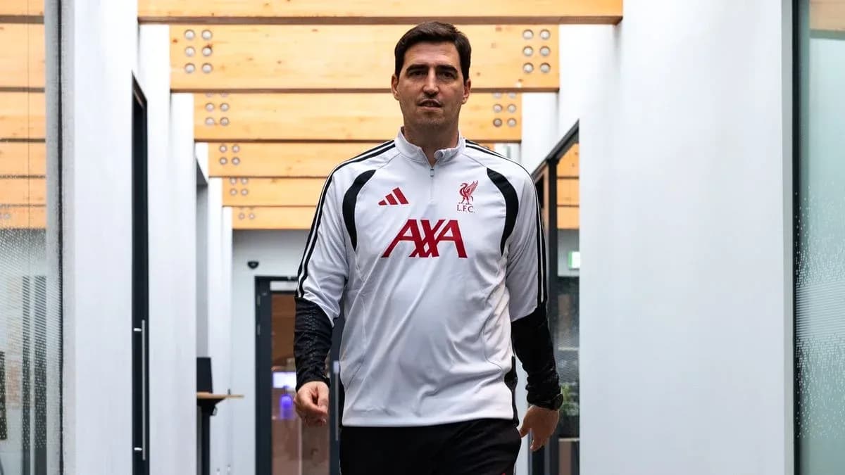 Liverpool coach walking through training facility hallway Liverpool coach walking through training facility hallway