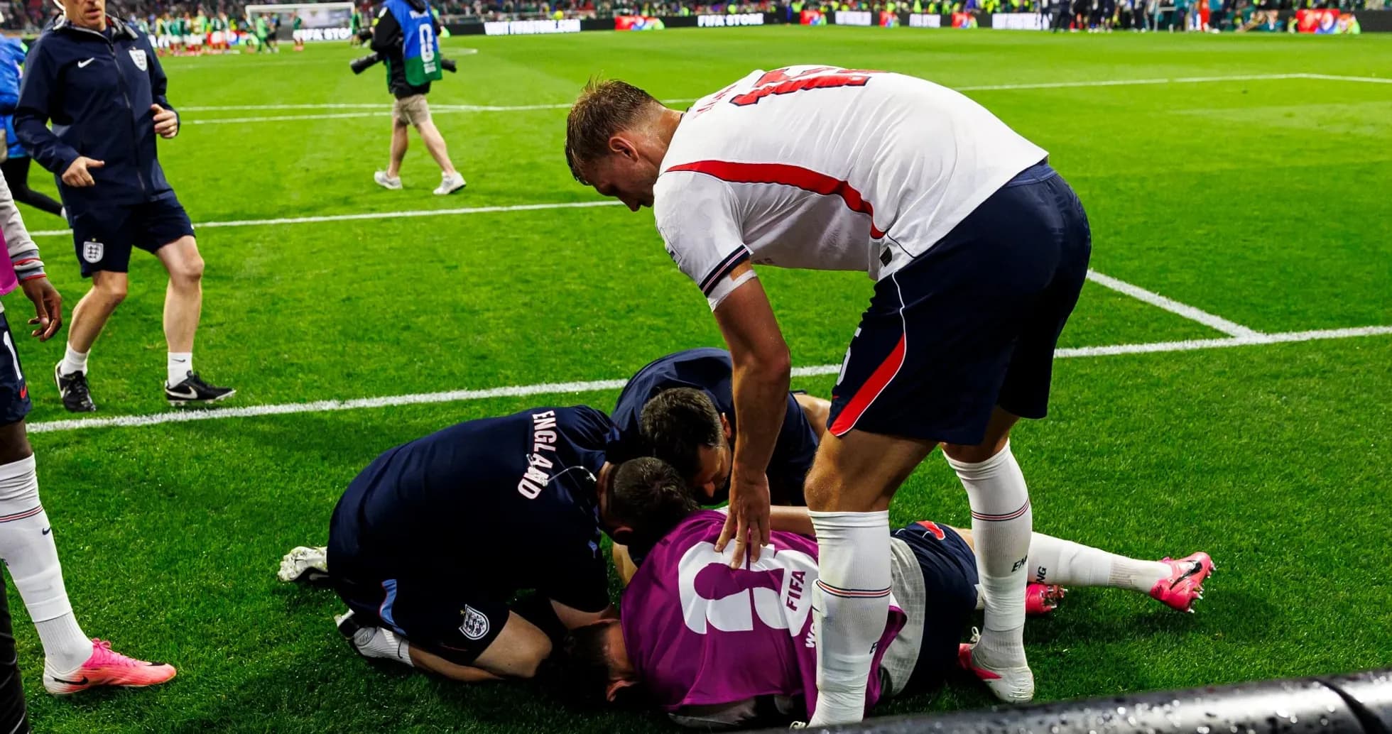 Players and staff attending to a downed goalkeeper Players and staff attending to a downed goalkeeper