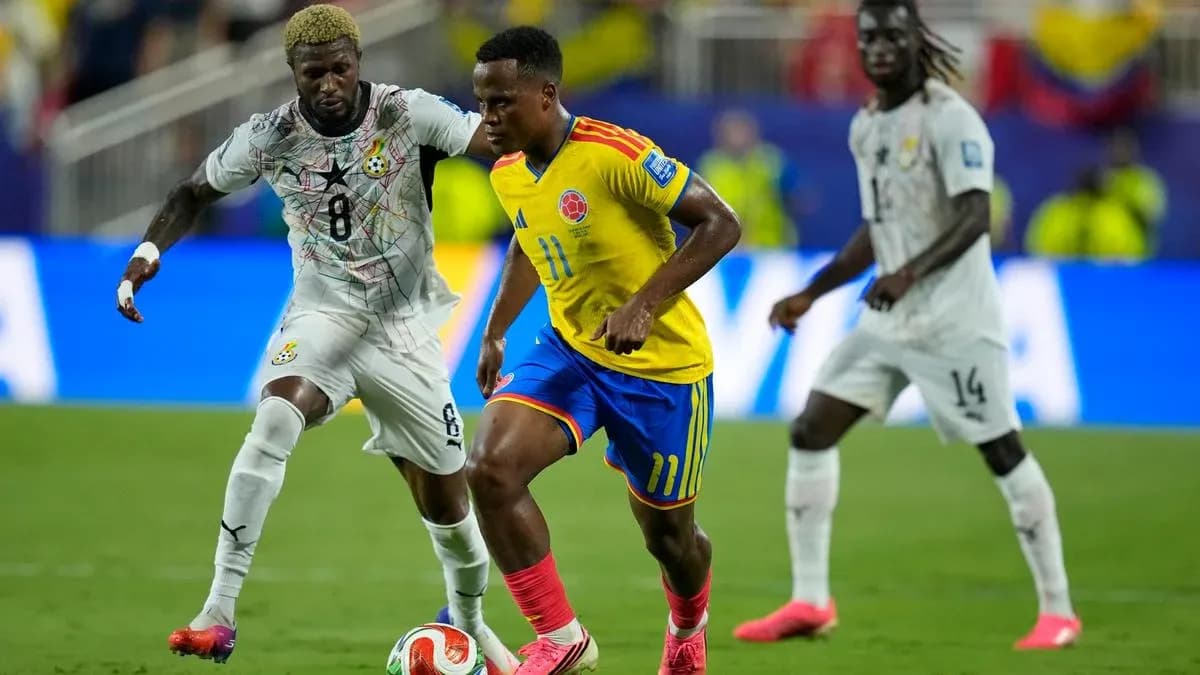 Colombian player dribbling past Ghanaian opponent Colombian player dribbling past Ghanaian opponent