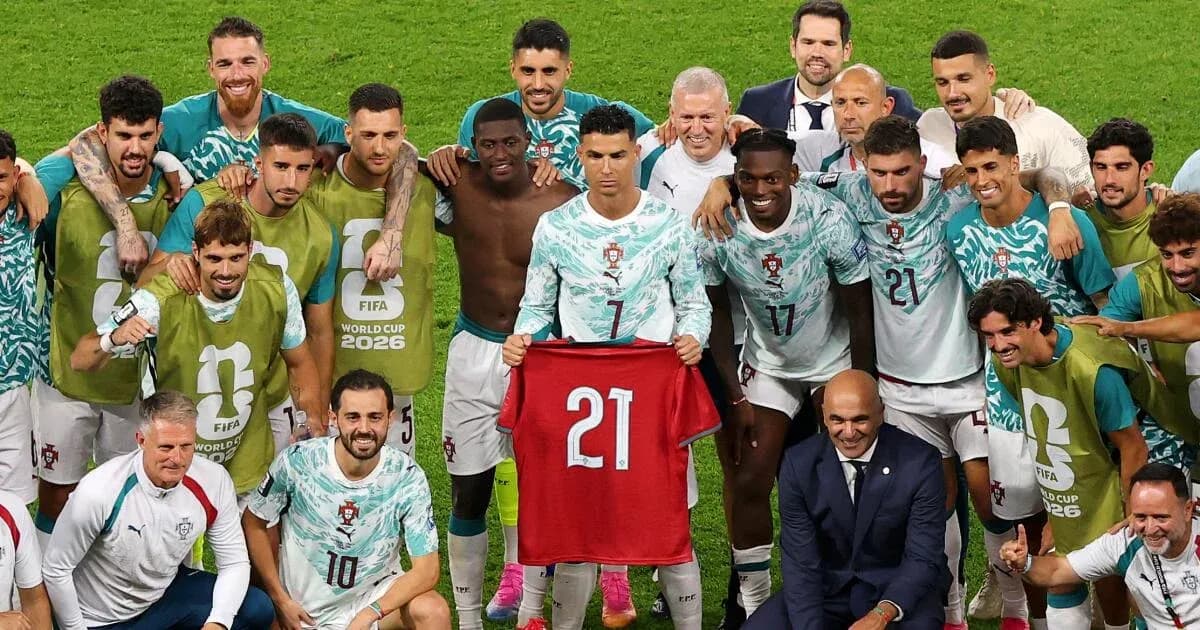 Portugal team celebrating with player holding jersey Portugal team celebrating with player holding jersey
