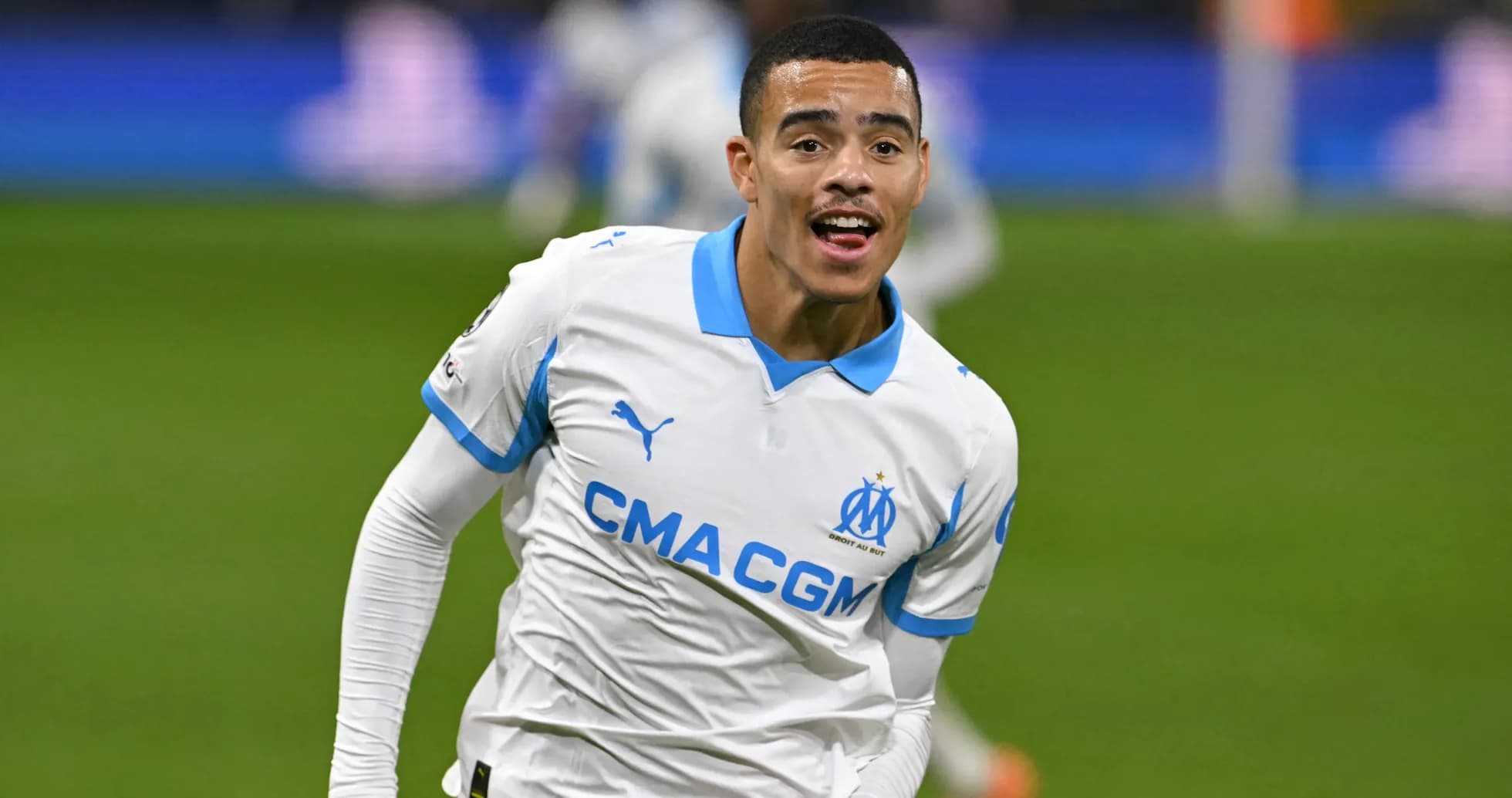 Player celebrating a goal wearing Marseille jersey Player celebrating a goal wearing Marseille jersey