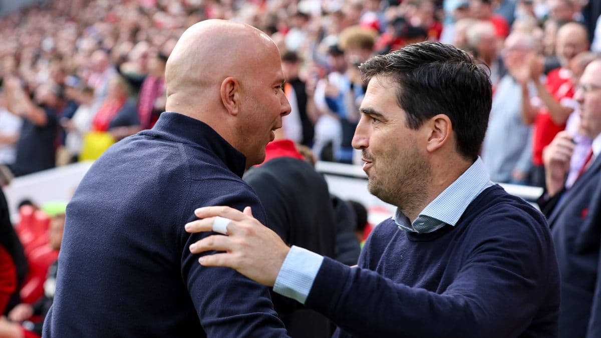 Two coaches greeting each other in the stands Two coaches greeting each other in the stands