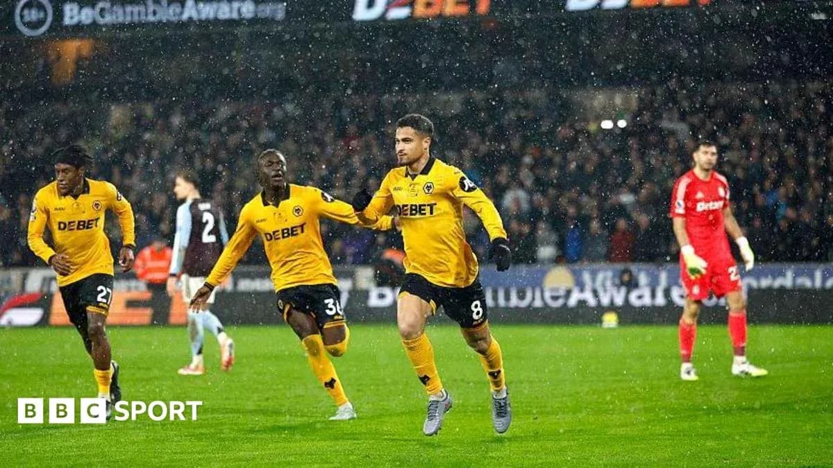Wolverhampton players celebrating a goal in rain Wolverhampton players celebrating a goal in rain