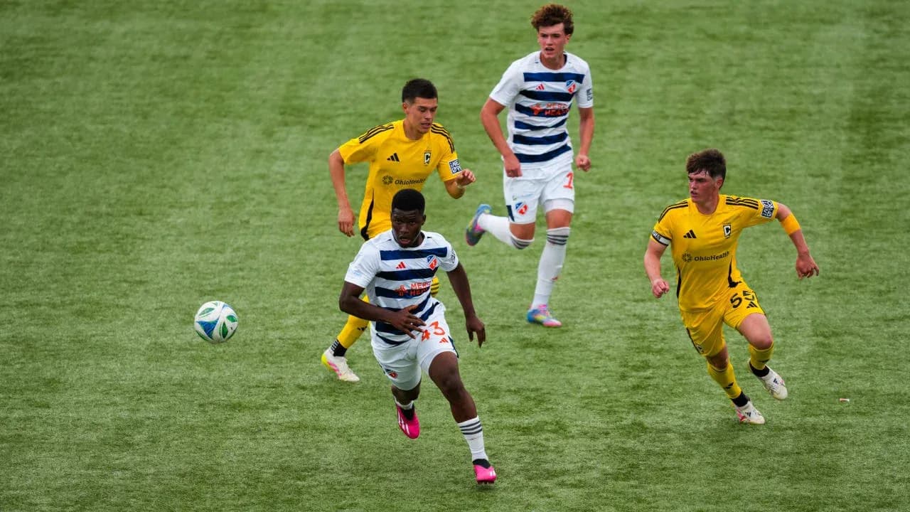 FC Cincinnati II player dribbling past Columbus Crew II opponents FC Cincinnati II player dribbling past Columbus Crew II opponents