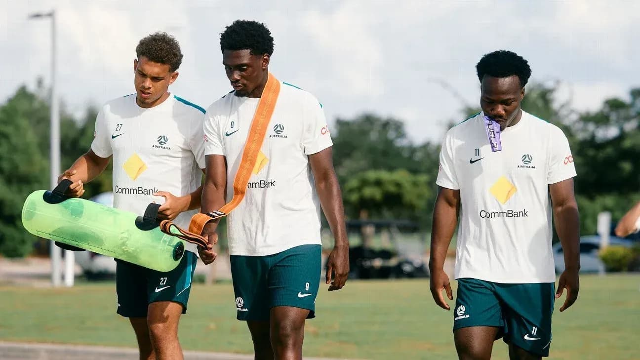 Three players walking during training session outdoors Three players walking during training session outdoors