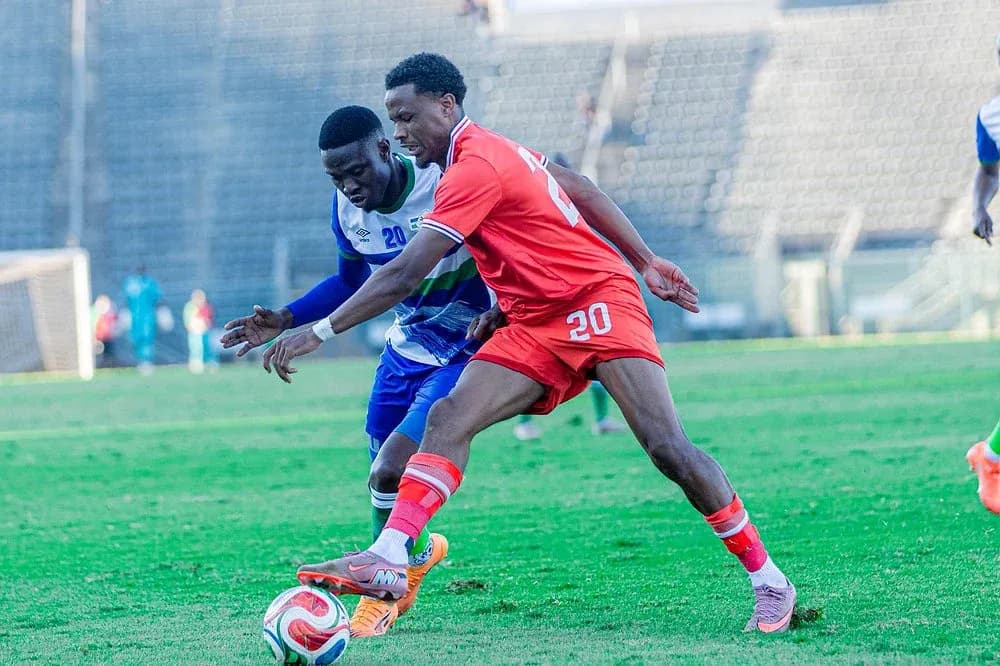 Two players competing for the ball in a match Two players competing for the ball in a match