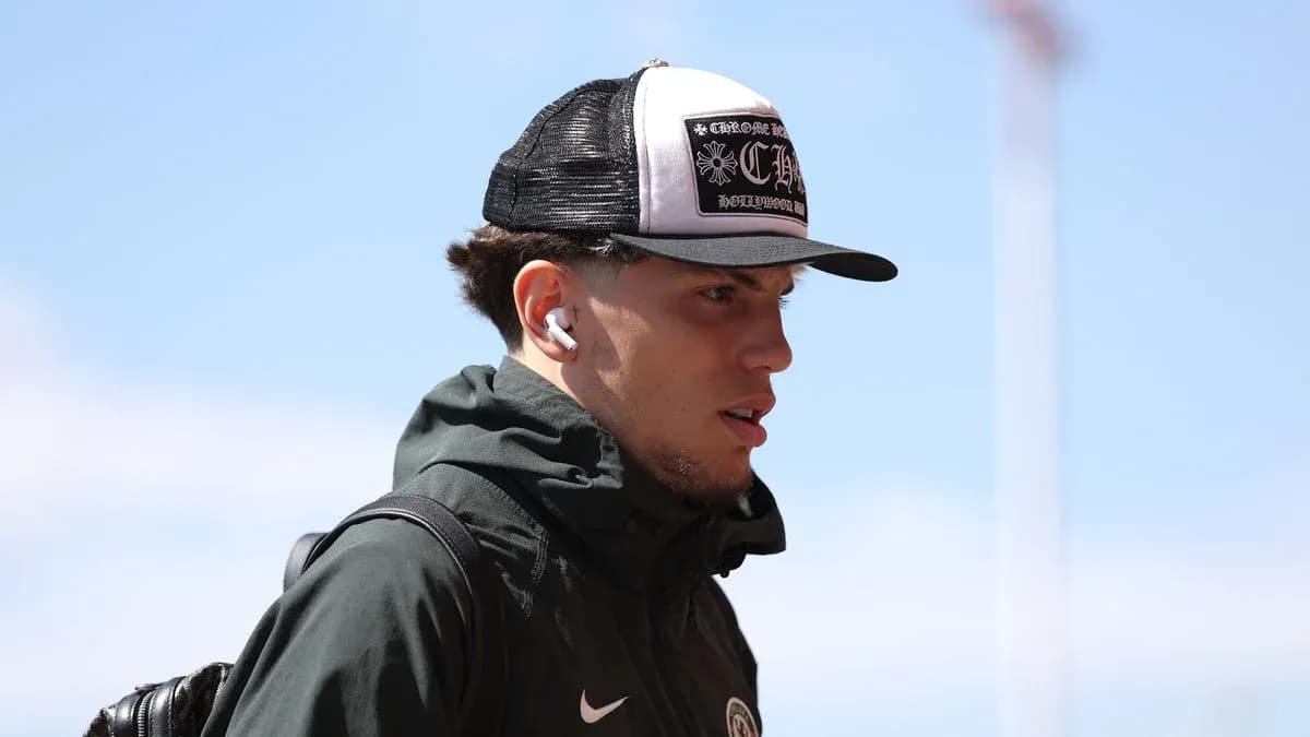 Player walking with headphones and cap outdoors Player walking with headphones and cap outdoors