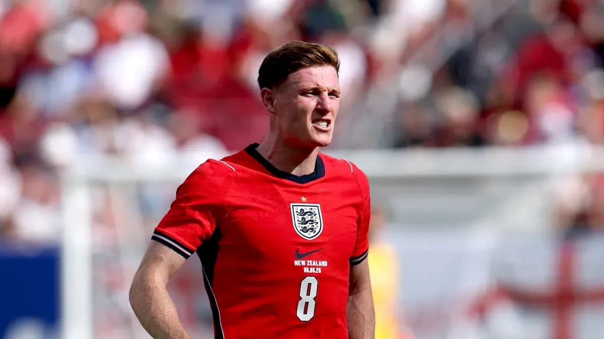 Player in red England jersey on the field Player in red England jersey on the field