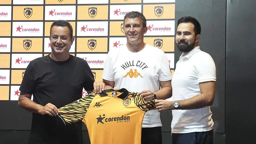 New coach holding Hull City jersey at presentation New coach holding Hull City jersey at presentation