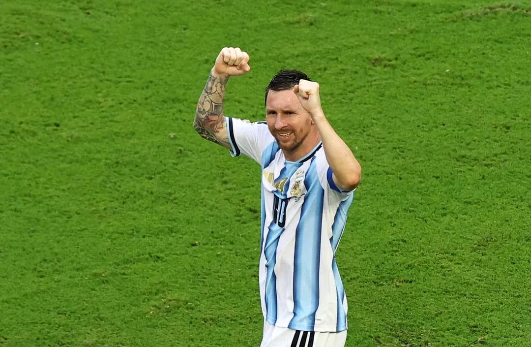 Player celebrating on the field with raised fists Player celebrating on the field with raised fists