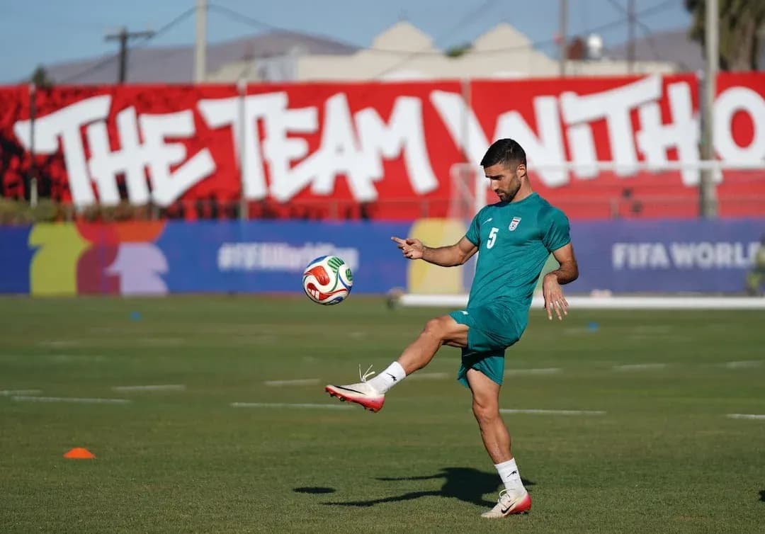 Iran player practicing with a football Iran player practicing with a football