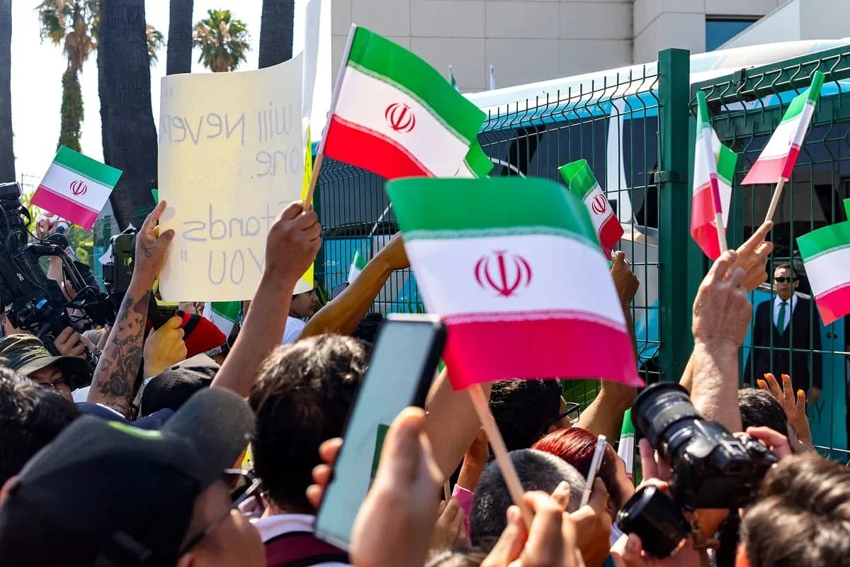 Crowd waving Iranian flags during protest event Crowd waving Iranian flags during protest event