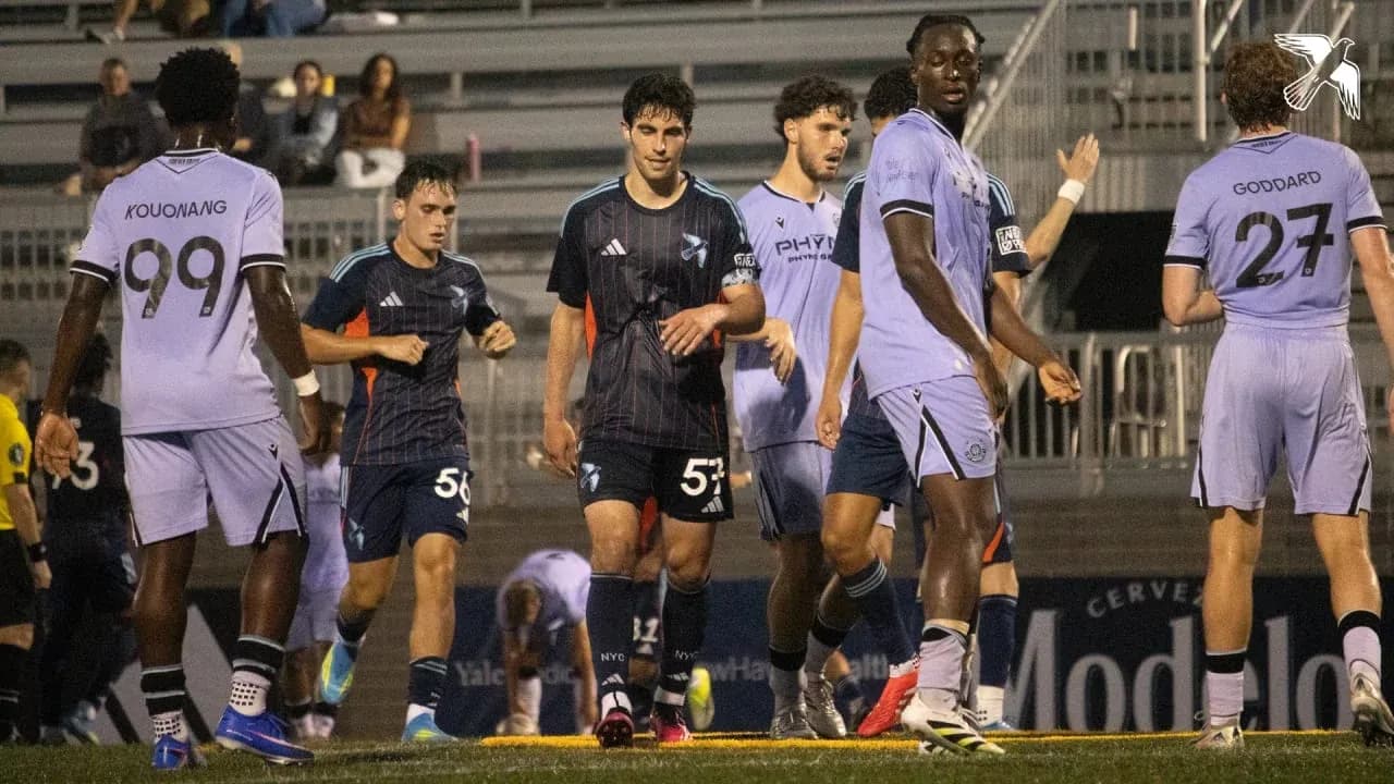 Players from New England II and New York City II on field Players from New England II and New York City II on field