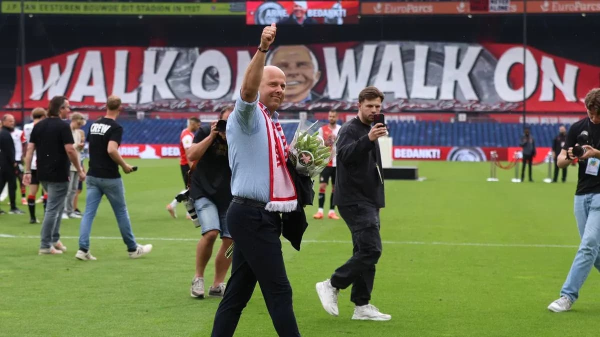 Man waving with flowers on football pitch Man waving with flowers on football pitch