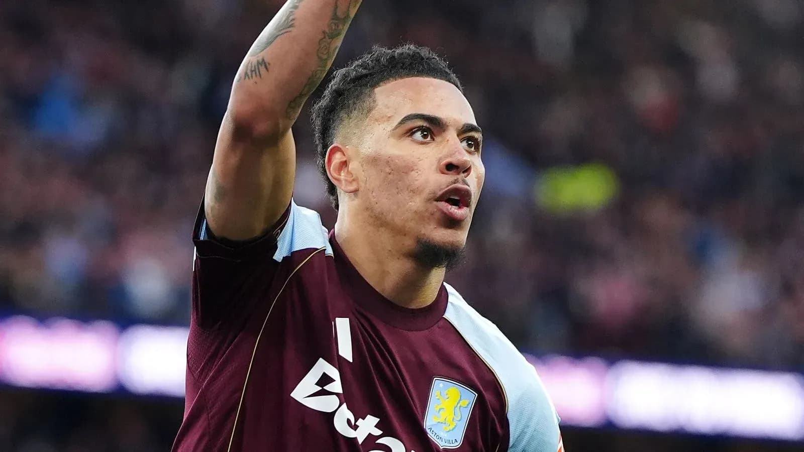 Aston Villa player celebrating with raised arm Aston Villa player celebrating with raised arm