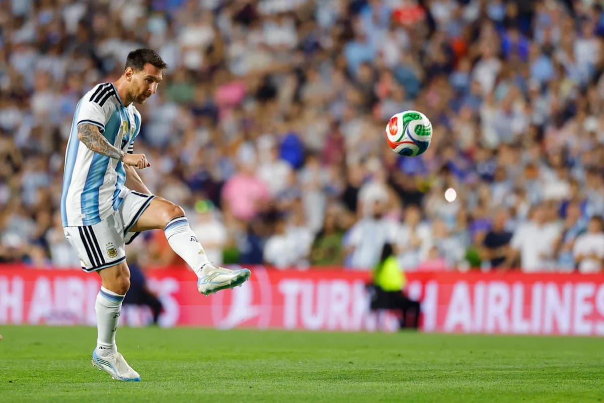 Lionel Messi kicking a soccer ball during match Lionel Messi kicking a soccer ball during match