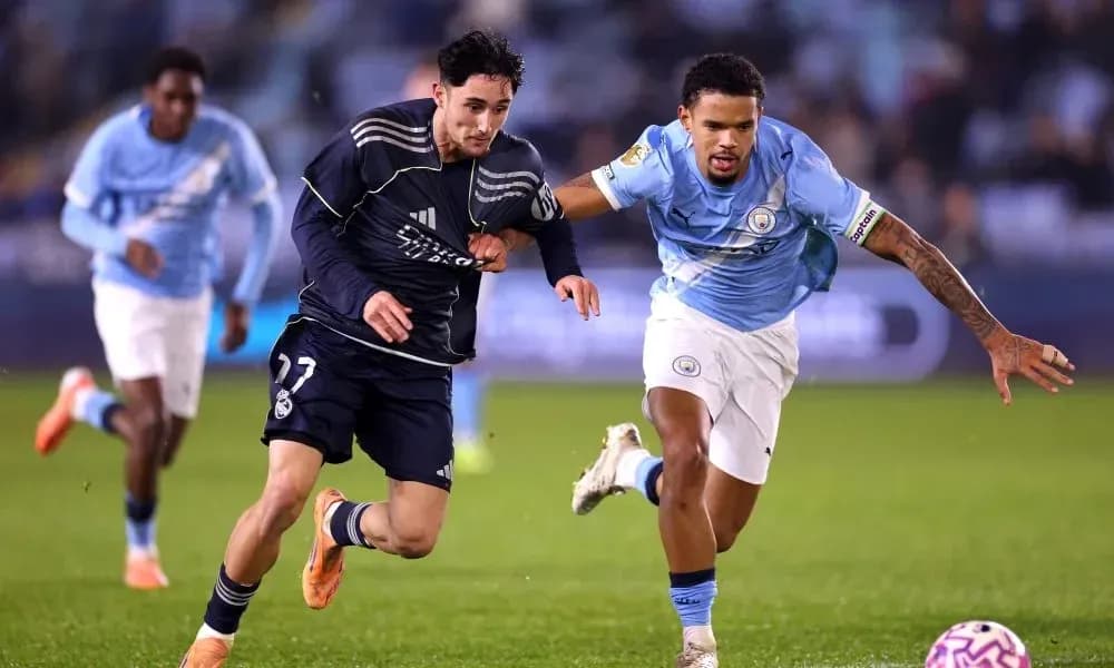 Real Madrid player sprinting past Manchester City defender Real Madrid player sprinting past Manchester City defender