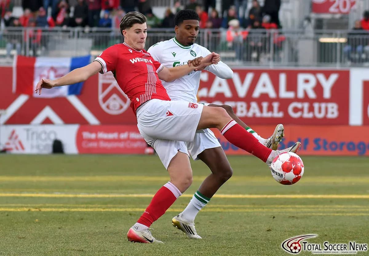 York United player tackling Cavalry FC opponent York United player tackling Cavalry FC opponent