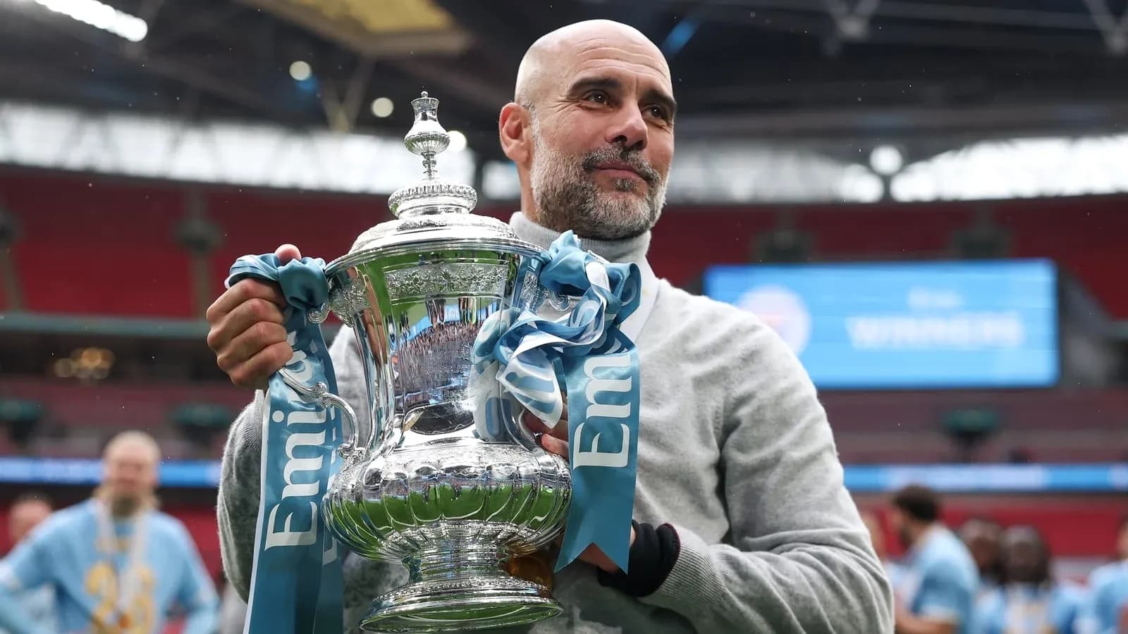 Manager holding trophy after cup final victory Manager holding trophy after cup final victory