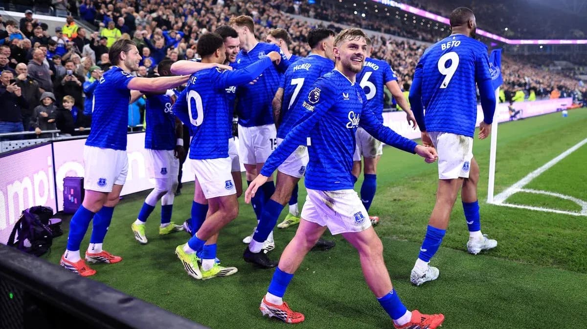 Everton players celebrating a goal with fans Everton players celebrating a goal with fans