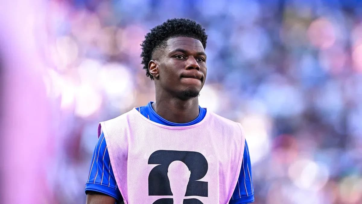 Player wearing training bib on sidelines during match Player wearing training bib on sidelines during match