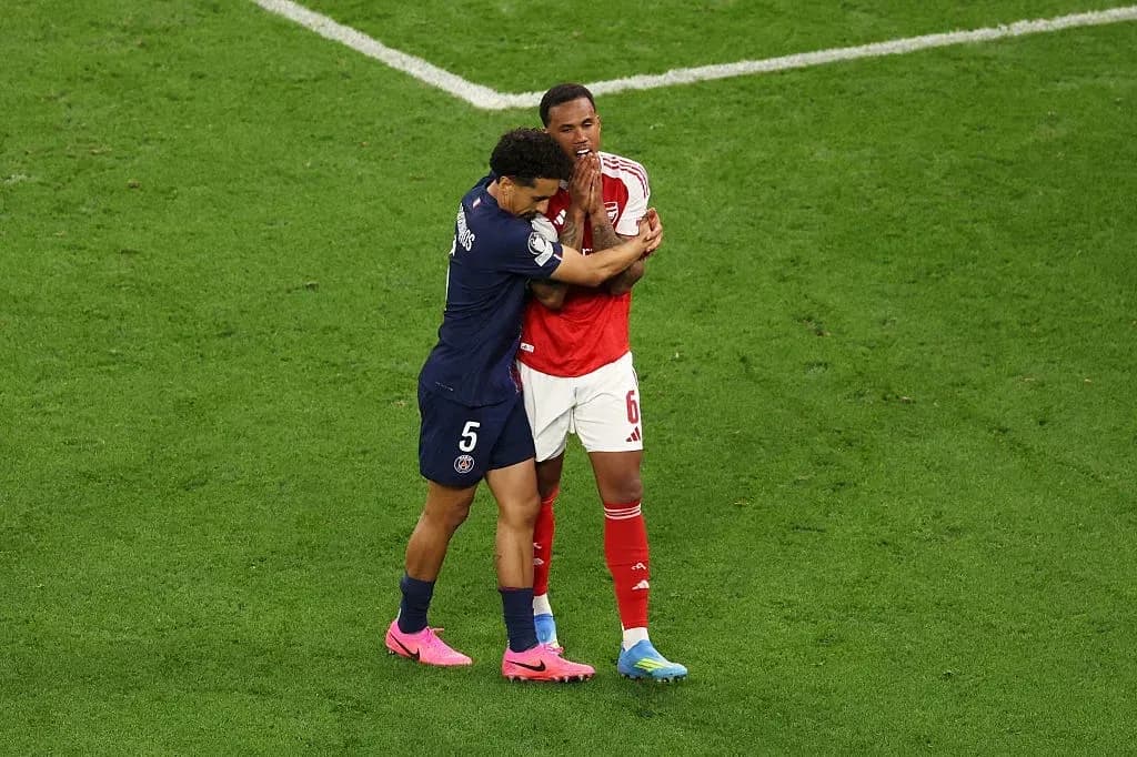 Two players embracing on the football pitch Two players embracing on the football pitch