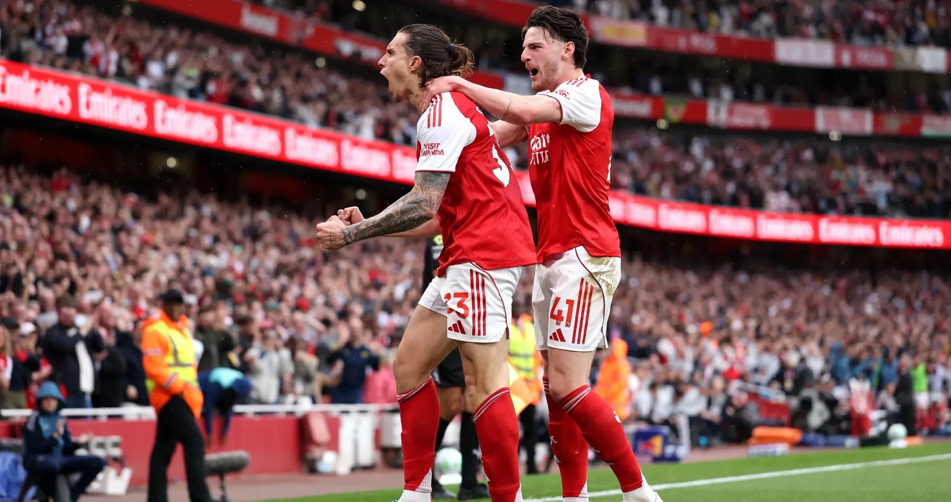 Arsenal players celebrating a goal on the pitch Arsenal players celebrating a goal on the pitch