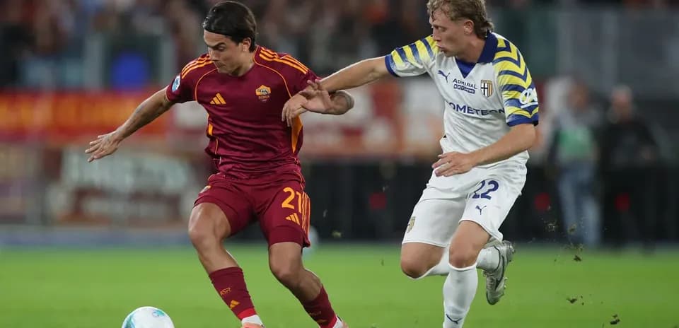 AS Roma player dribbling past Parma defender AS Roma player dribbling past Parma defender