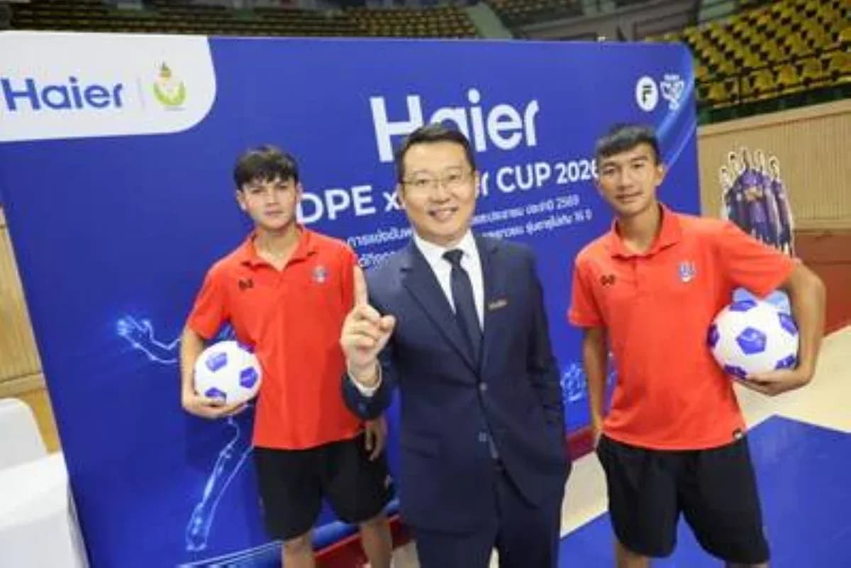 Two young players with a businessman and soccer balls Two young players with a businessman and soccer balls